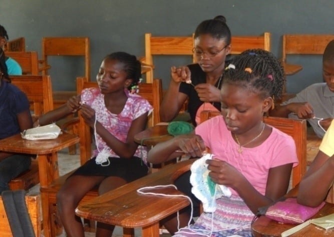 Youth learning how to crochet