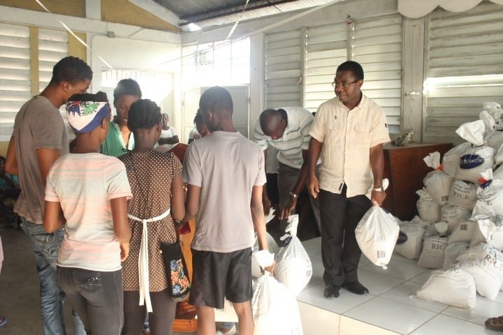 Fr. Jean Paul Mesidor, provincial of the Salesians in Haiti, aiding with the food distribution