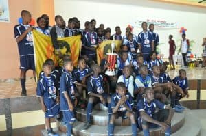 Two teams from Cayes show off their trophies